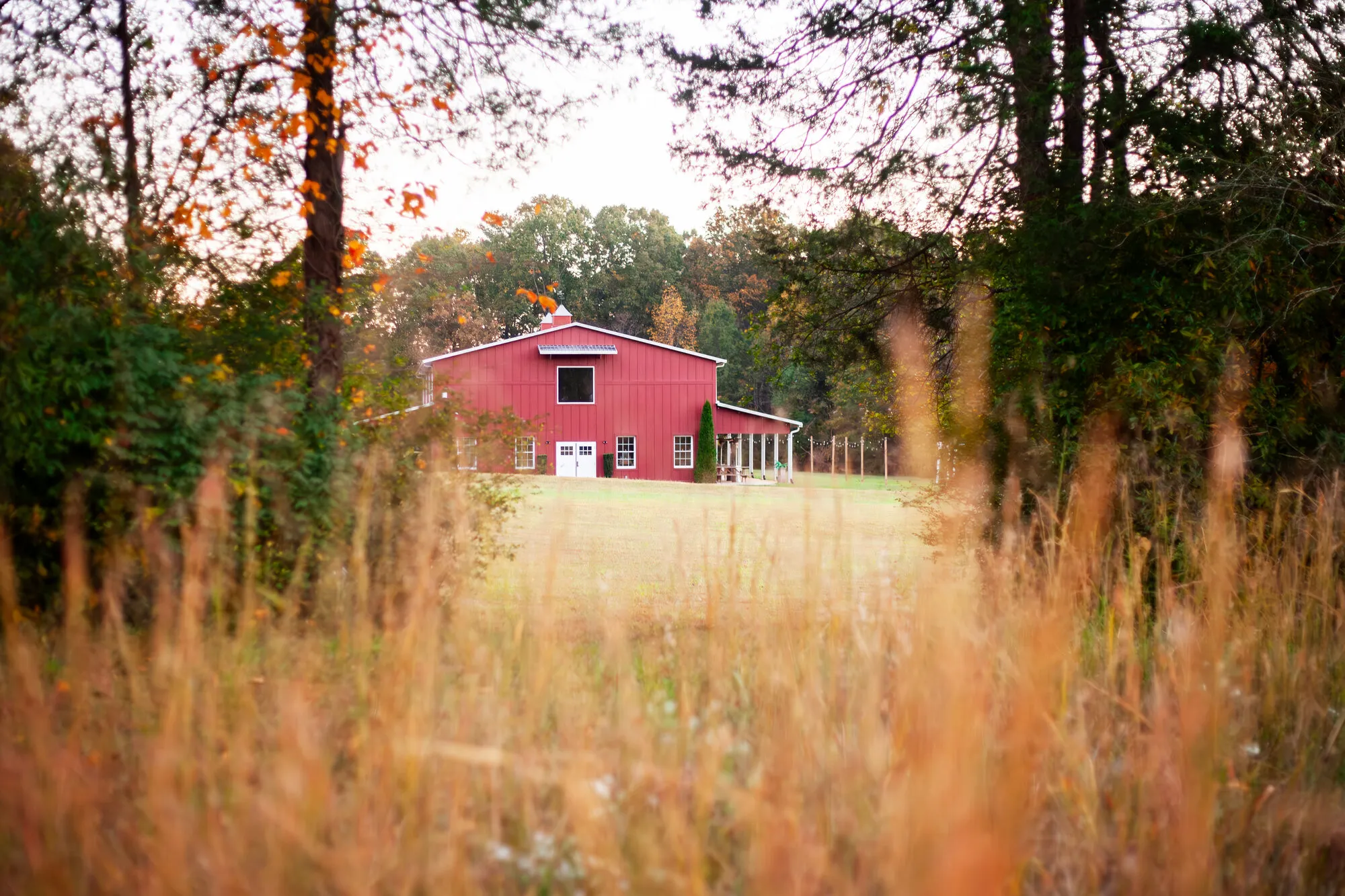The red barn at The Heritage Barn glowing across the 30-acre grounds near Hickory, NC