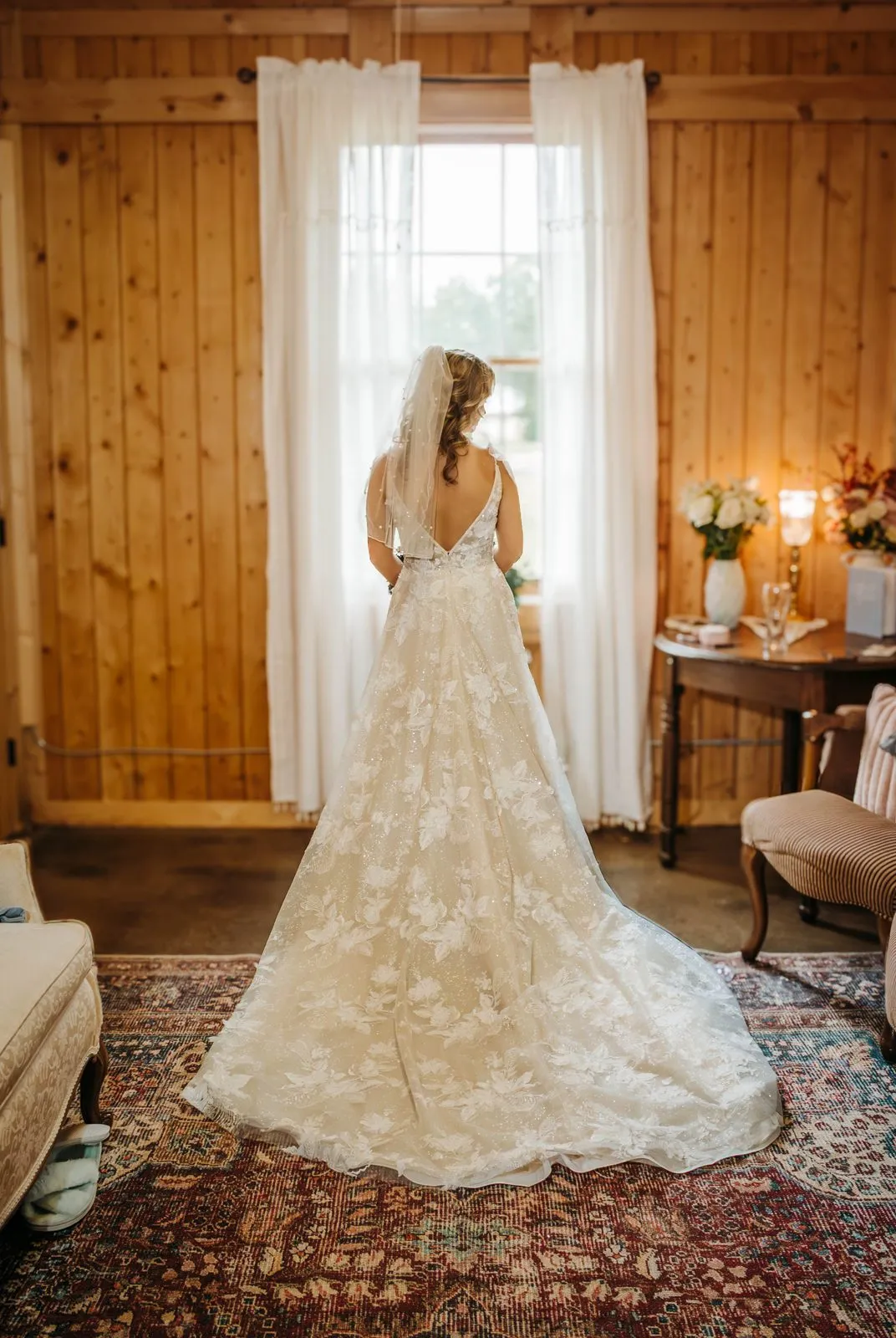Bride in the bright, naturally lit bridal suite at The Heritage Barn