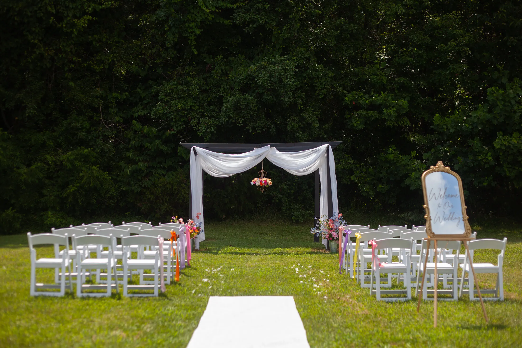Outdoor ceremony lawn with a draped arch at The Heritage Barn in Conover, NC