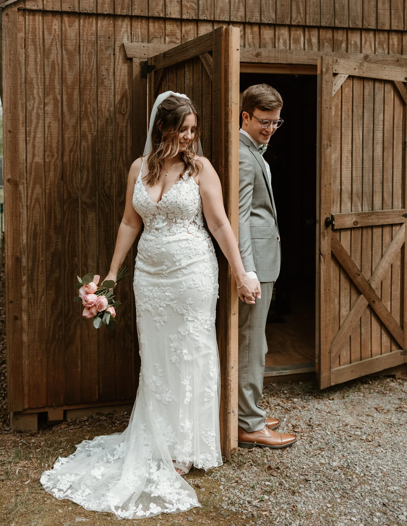 Newlyweds in the barn doors at The Heritage Barn