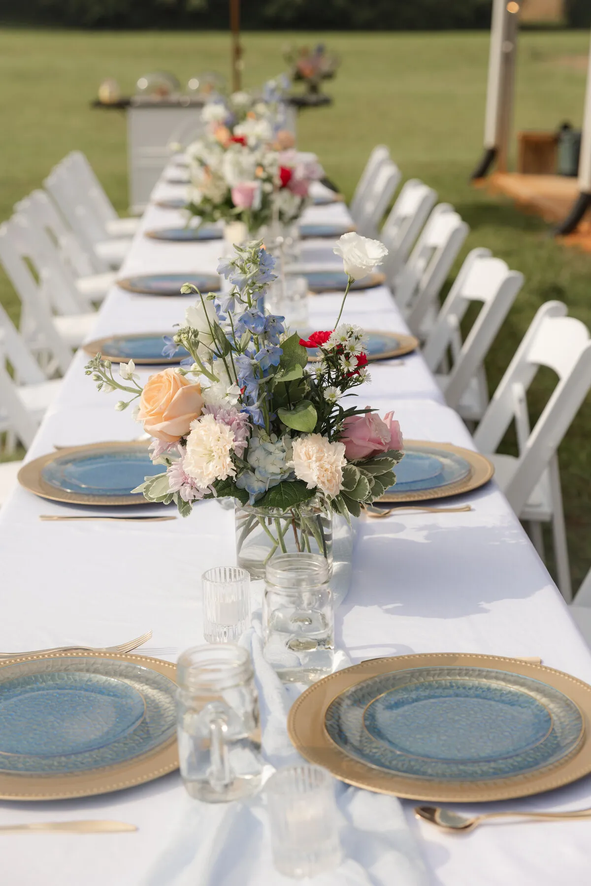 Long reception table with a floral runner at The Heritage Barn